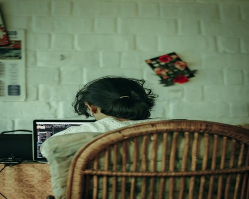 person working on a laptop at home in India