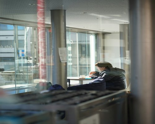 student reading notes in soft light